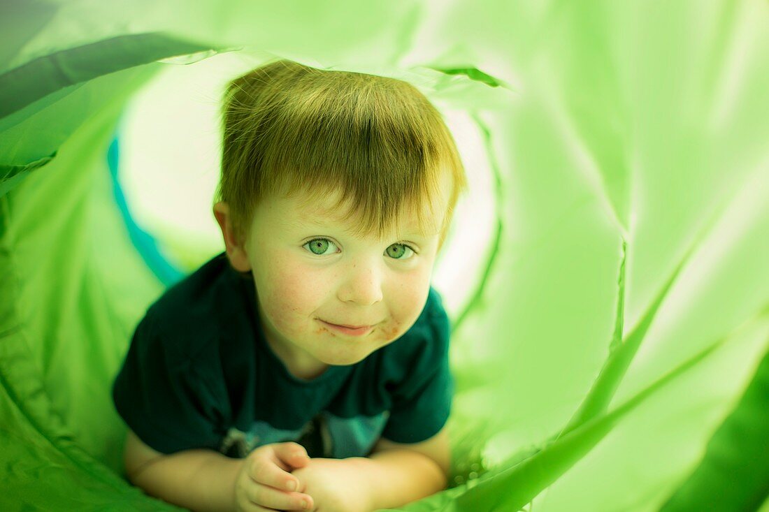 Boy in green tunnel