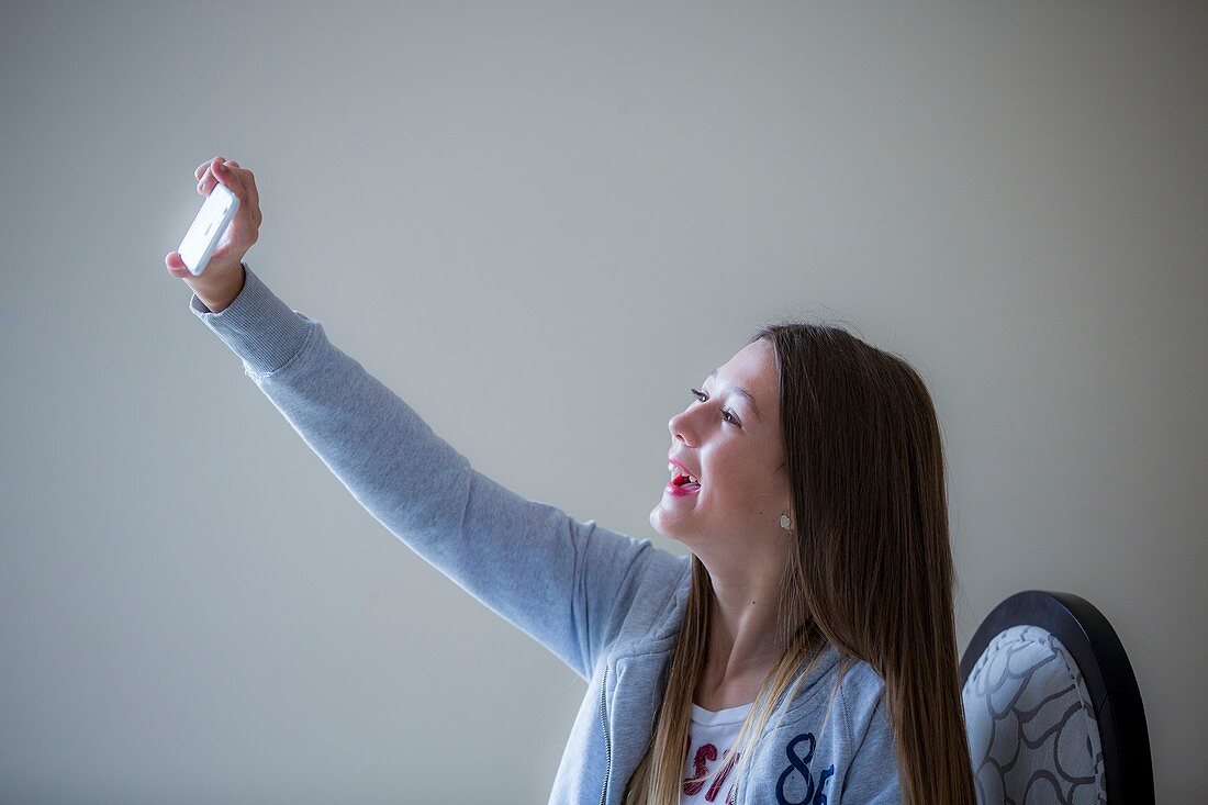 Girl taking selfie on smartphone