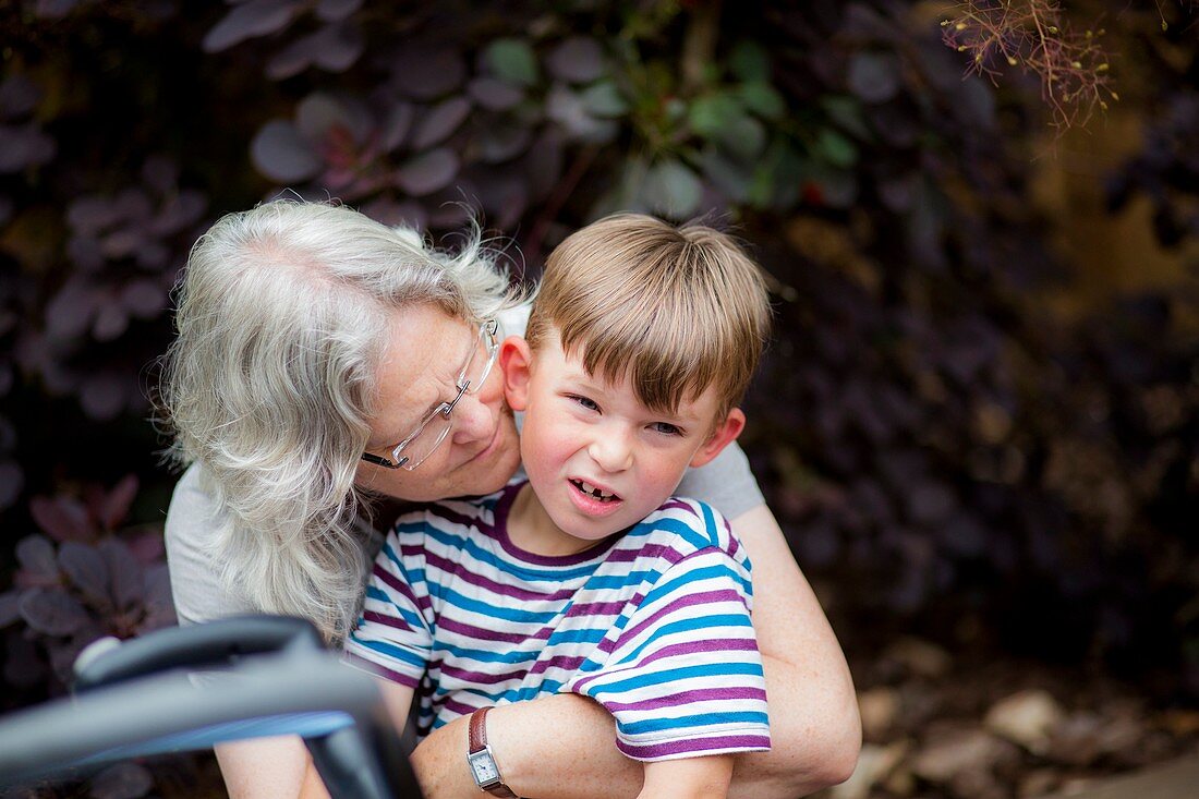 Grandmother hugging grandson