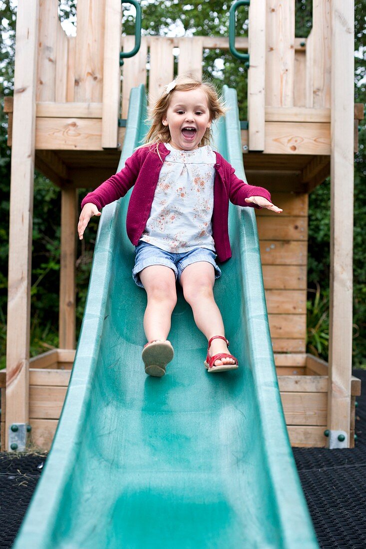 Girl sliding down a slide