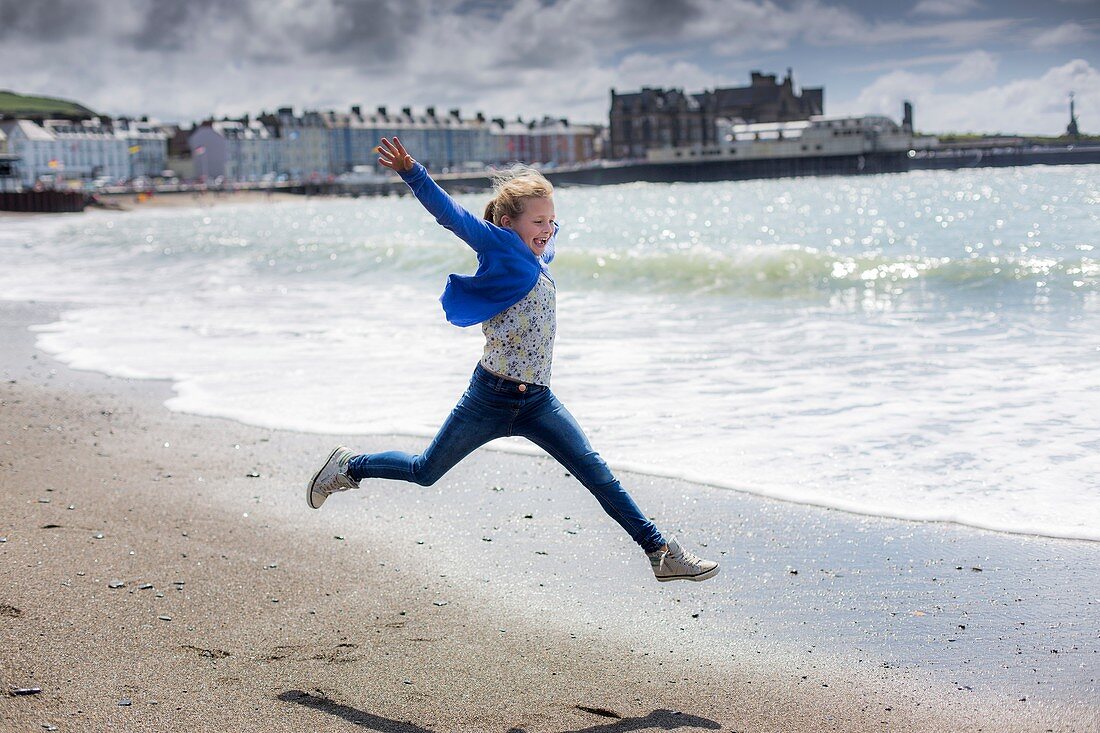 Girl leaping on beach