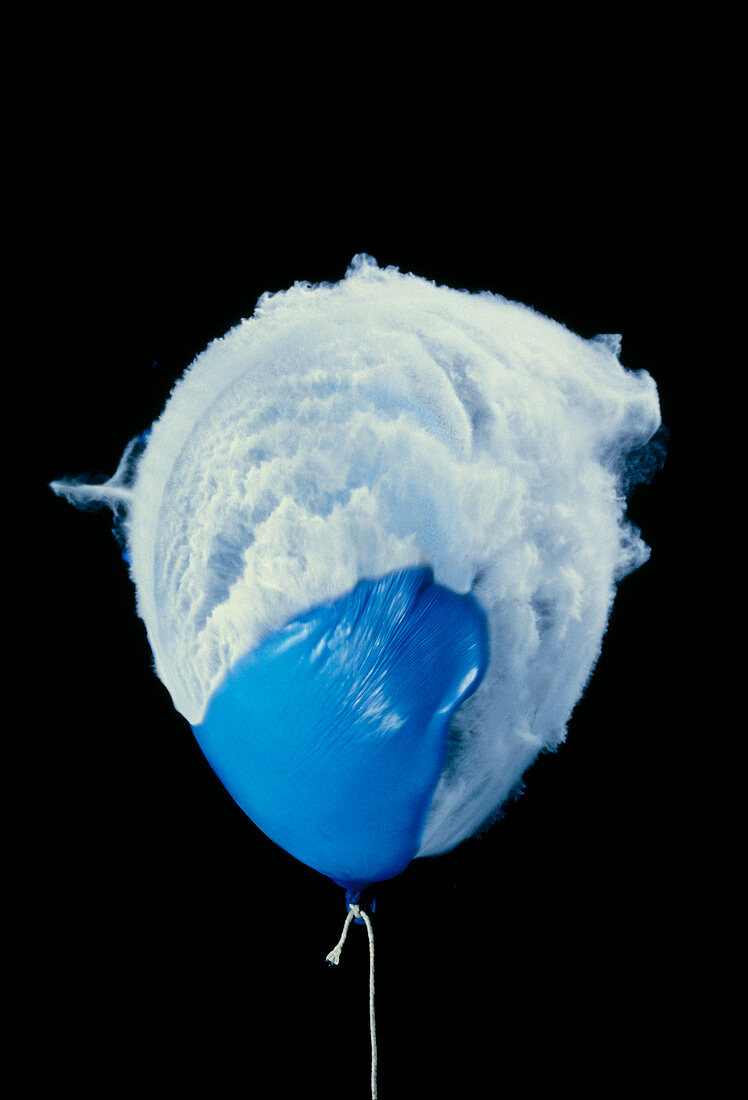 Air gun pellet bursting a balloon