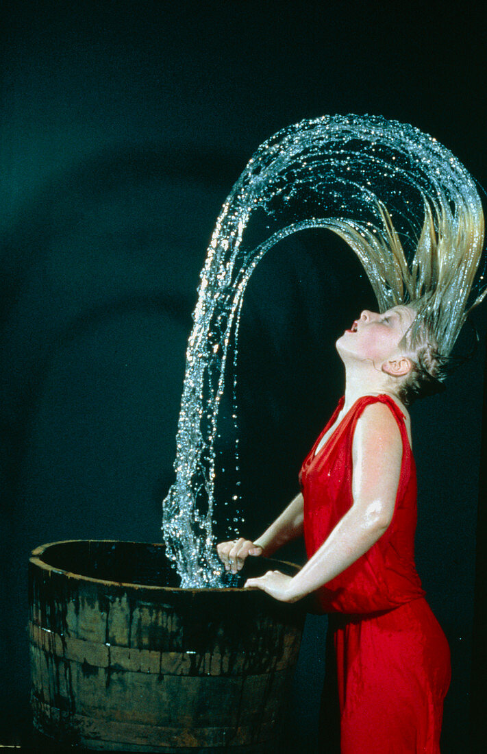 High speed photo of woman shaking wet hair