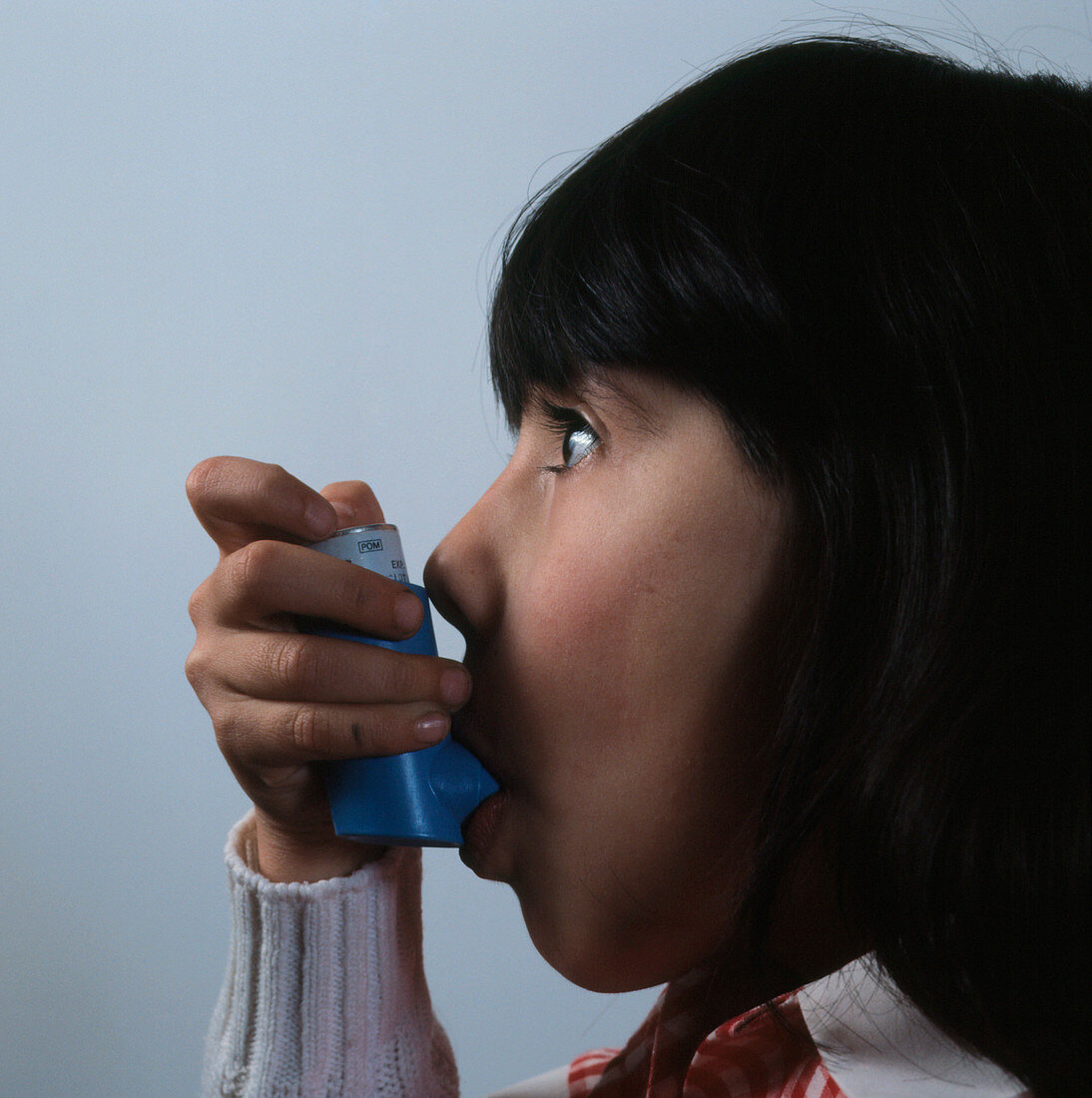 Young child using Brycanyl inhaler for asthma