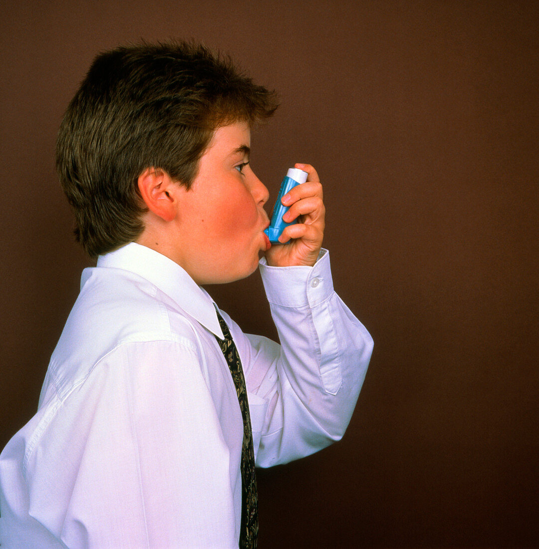Boy demonstrating aerosol inhaler technique