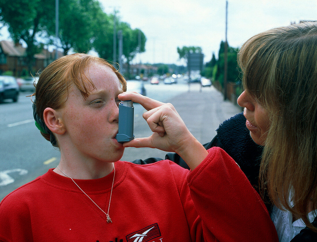 Girl uses an aerosol inhaler for asthma