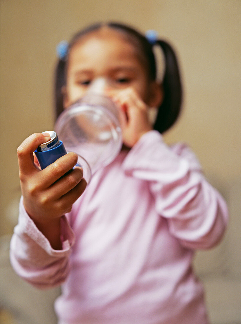 Girl using asthma inhaler