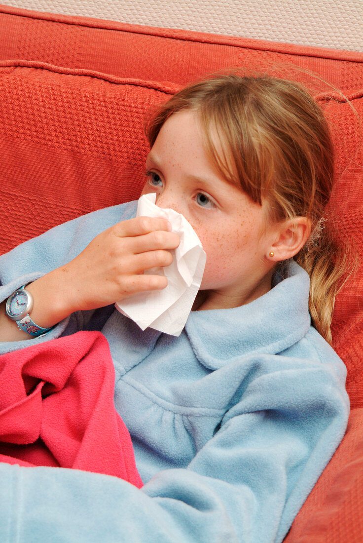 Girl blowing her nose