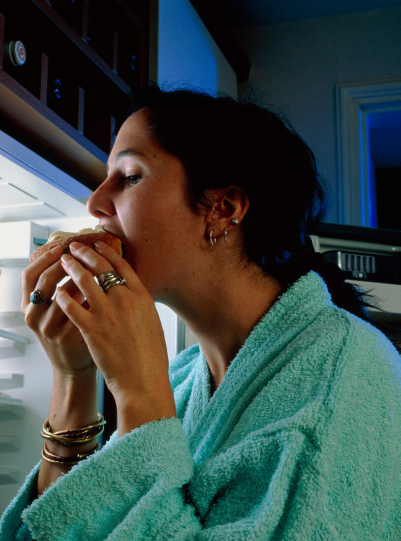 Eating disorder: young woman craving food at night