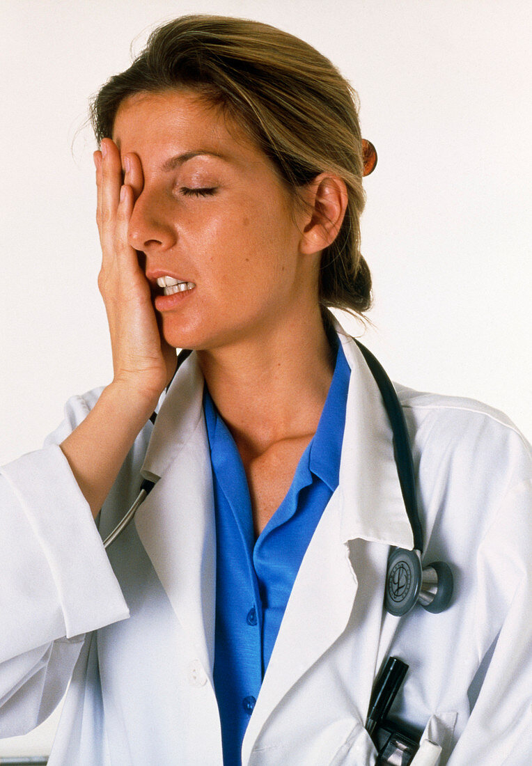 View of a tired and stressed female doctor