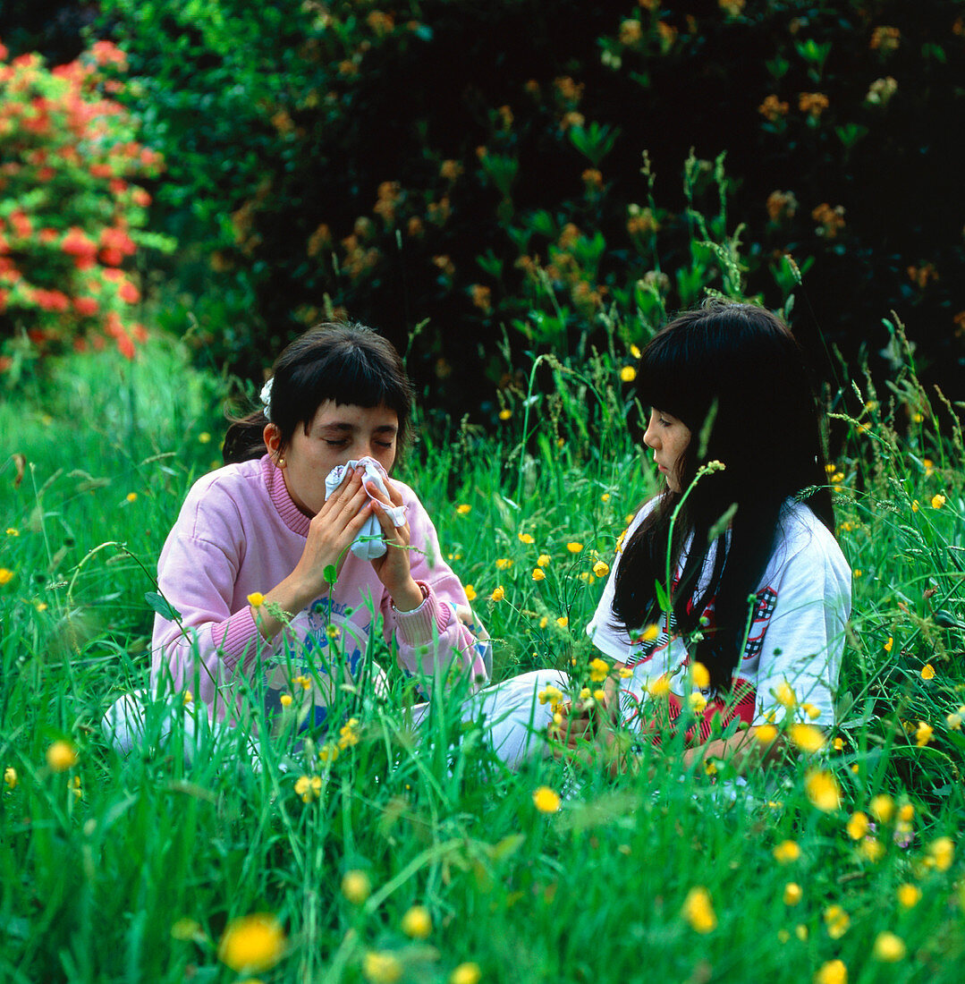 Young girl in a field suffering from hay fever