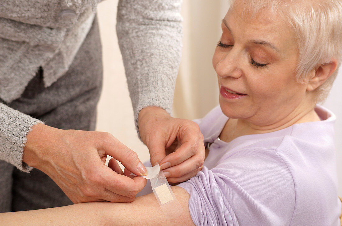 Woman applying a plaster