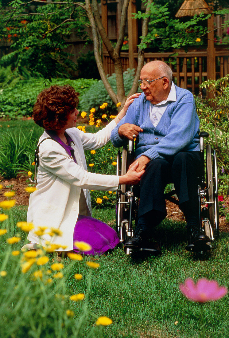 Disabled elderly man receiving home visit