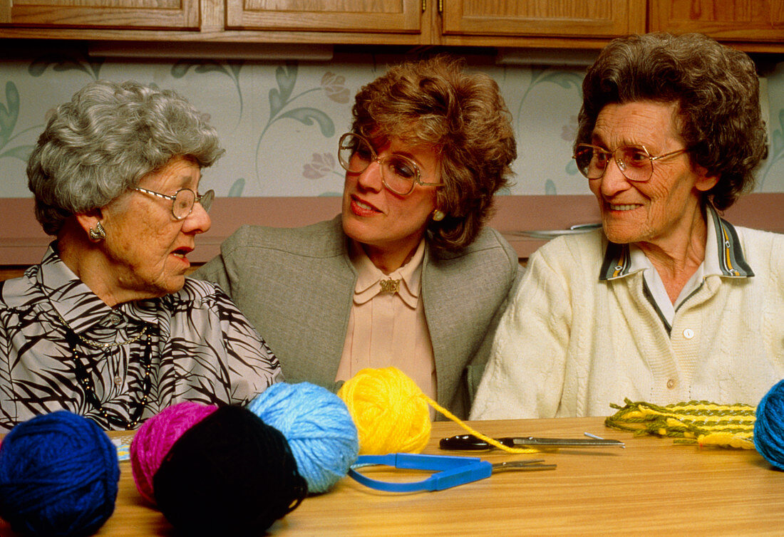 Old-age care: elderly women occupied with knitting