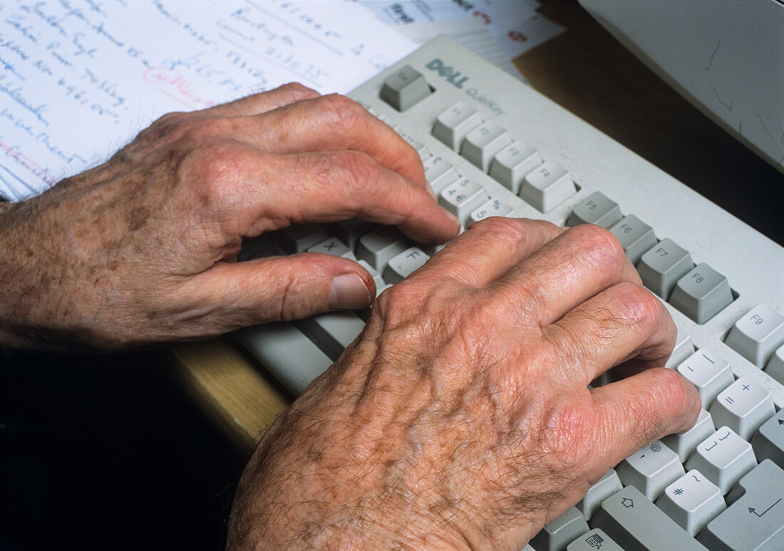 Elderly person typing