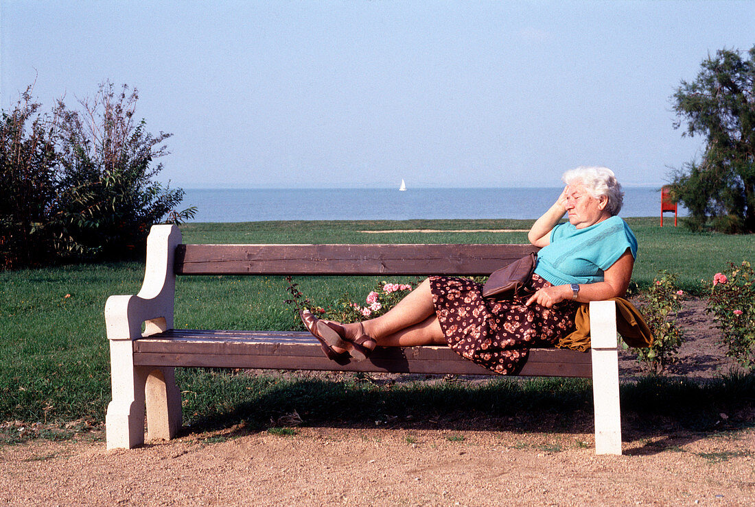 Pensioner relaxing on a bench