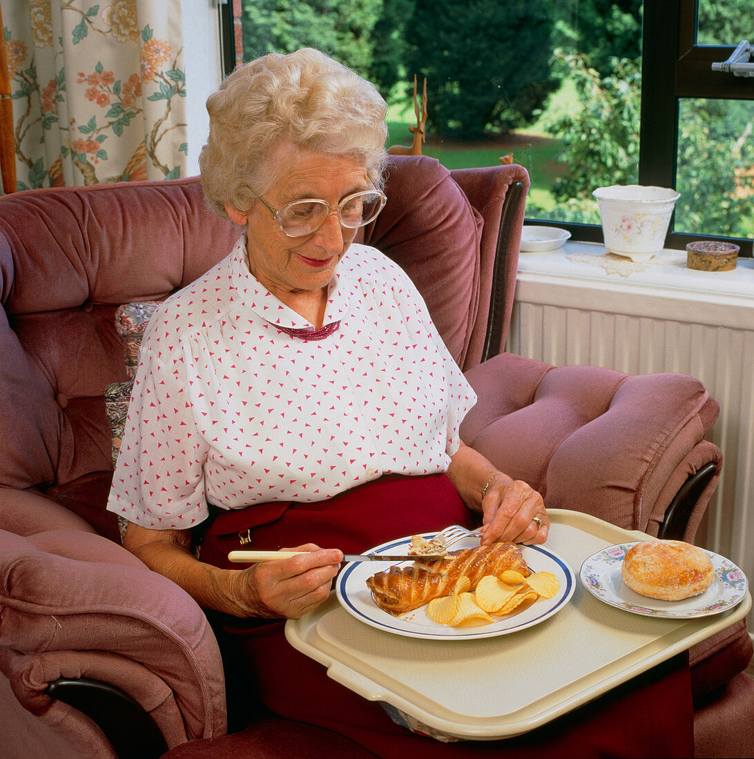 Elderly woman with unhealthy meal