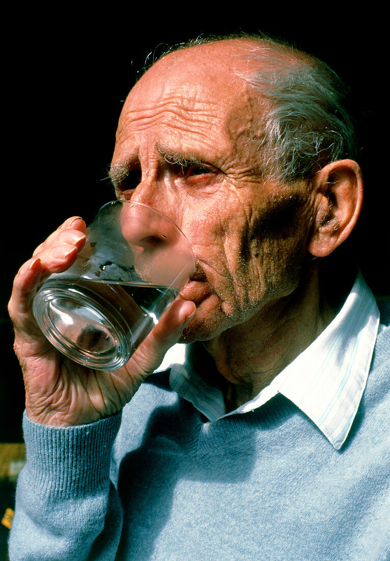 Elderly man drinking
