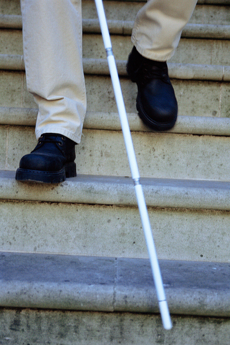 Blind man descending stairs