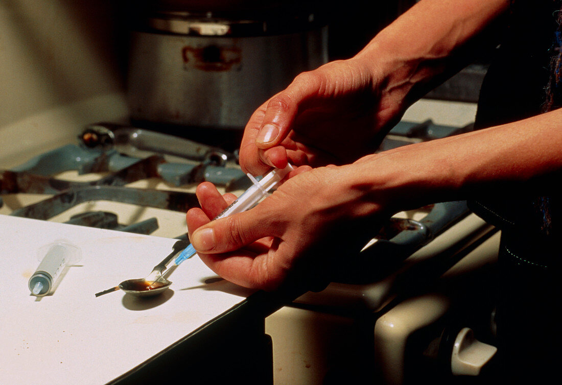 Drug addict preparing a heroin injection