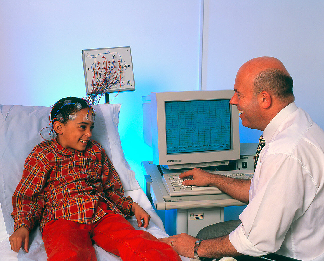 Doctor monitors boy's brain activity by EEG