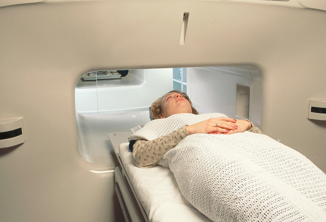 Woman in wide MRI scanner for claustrophobics