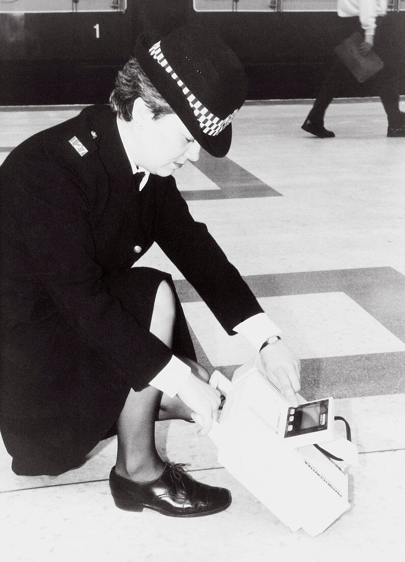 Policewoman demonstrates cardiac defibrillator