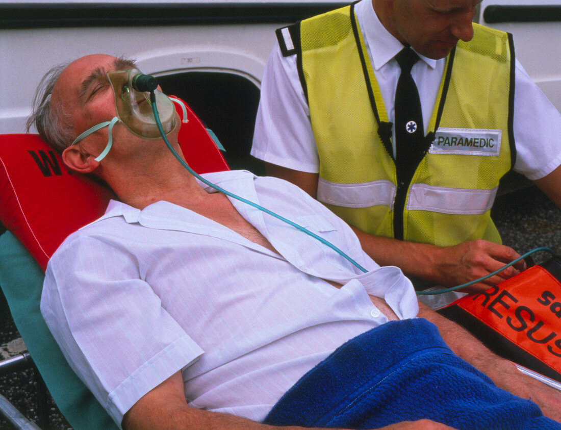 Patient being given oxygen by ambulance man