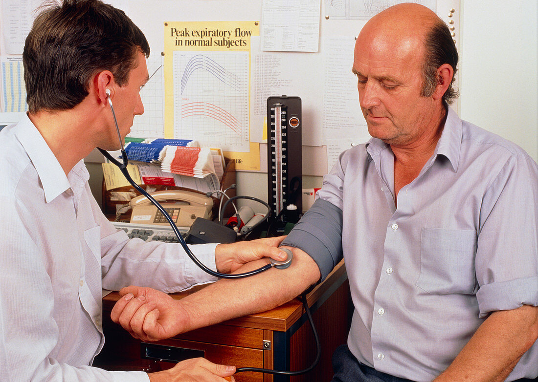 GP taking blood pressure reading