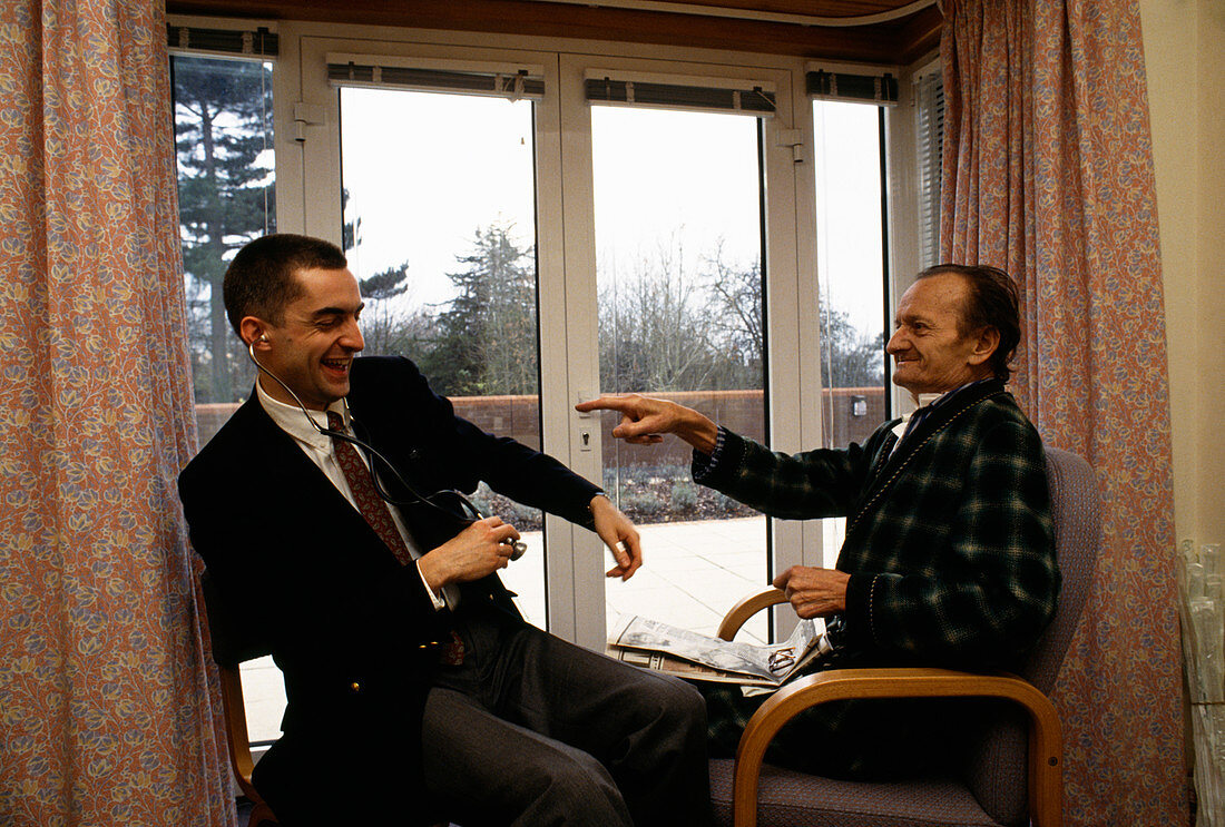 Hospice patient and doctor laughing