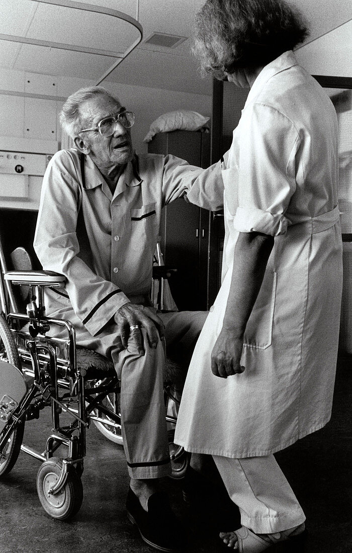 Nurse with elderly man in wheelchair