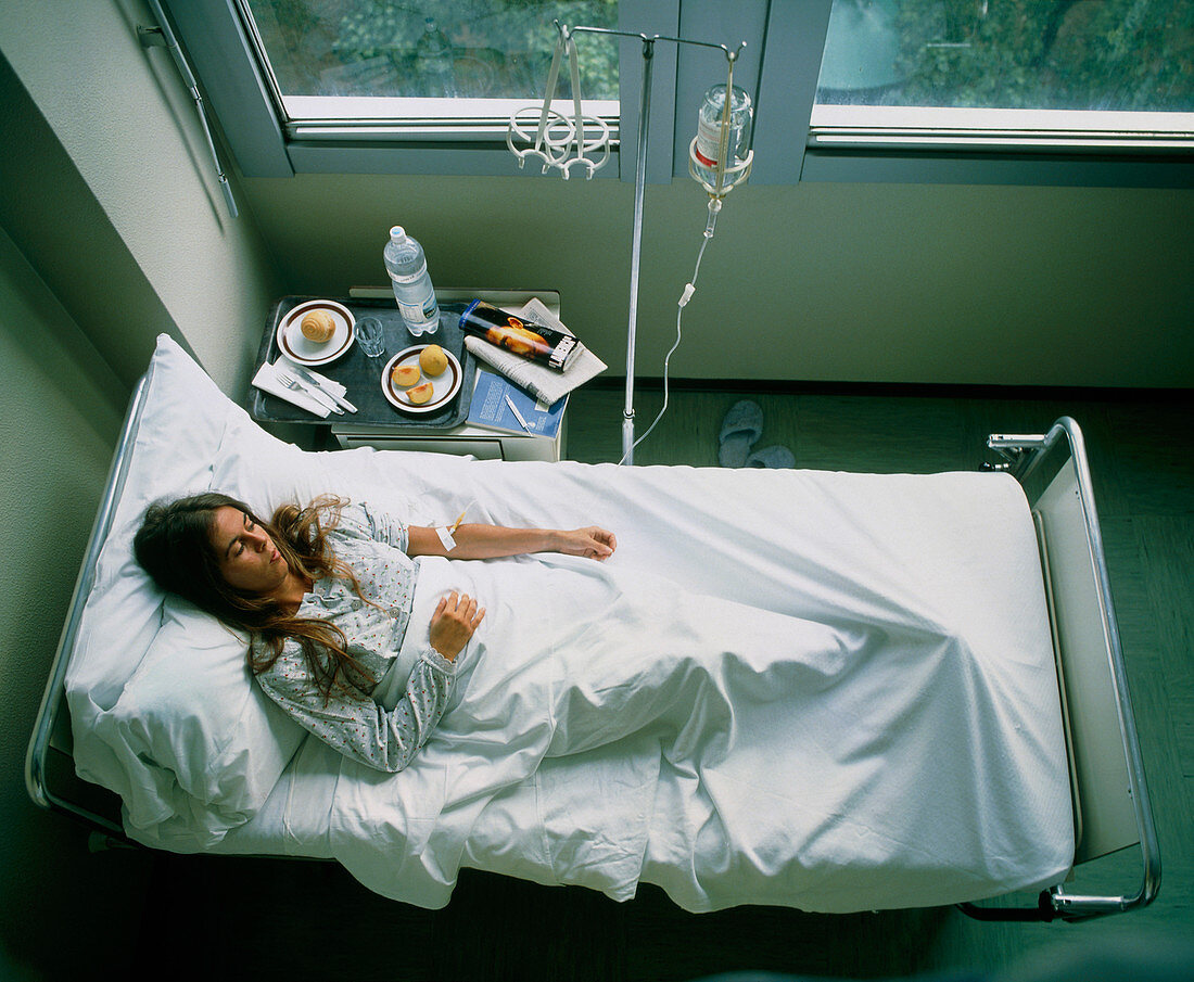 Woman on an intravenous drip on a hospital ward