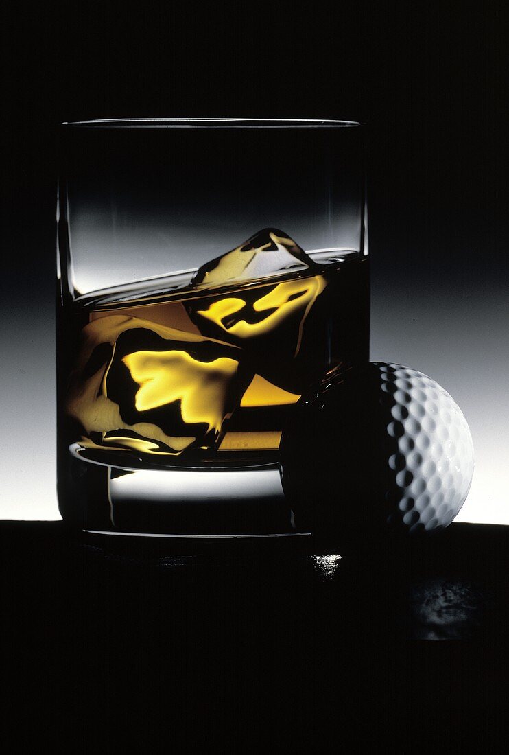 Glass of Whiskey on the Rocks; Golf Ball