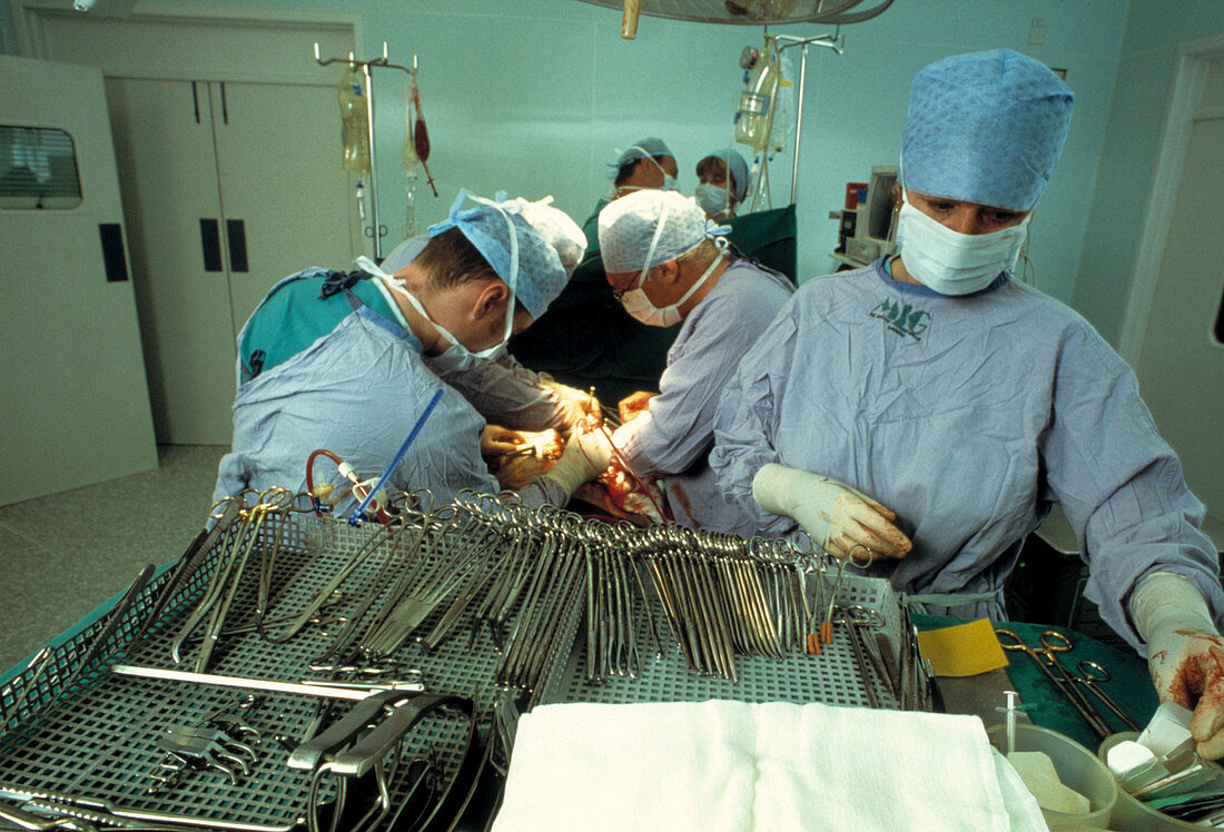 Surgical team repairing abdominal aortic aneurysm