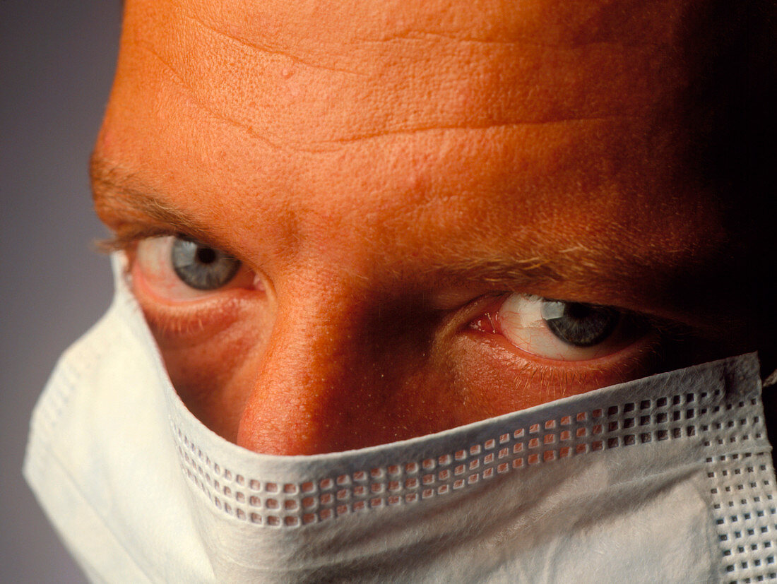 Masked face of a male surgeon