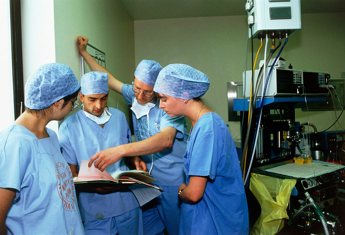 Surgeons discussing patient's notes before surgery