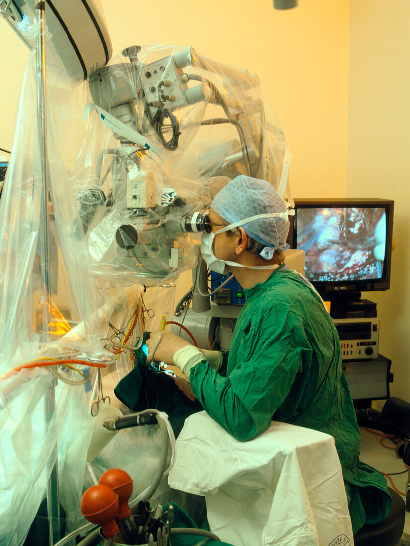 Neurosurgeon uses microscope during brain surgery