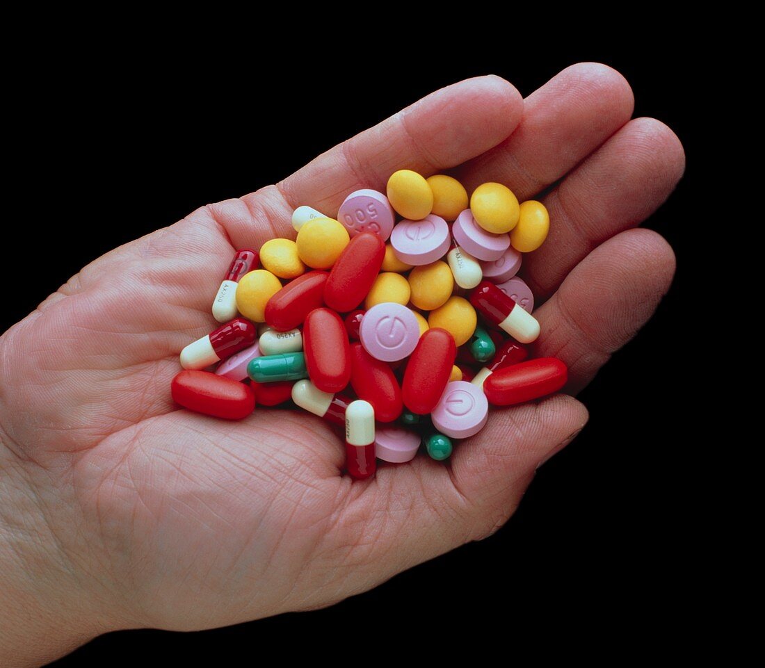Assortment of antibiotic drugs held in a hand
