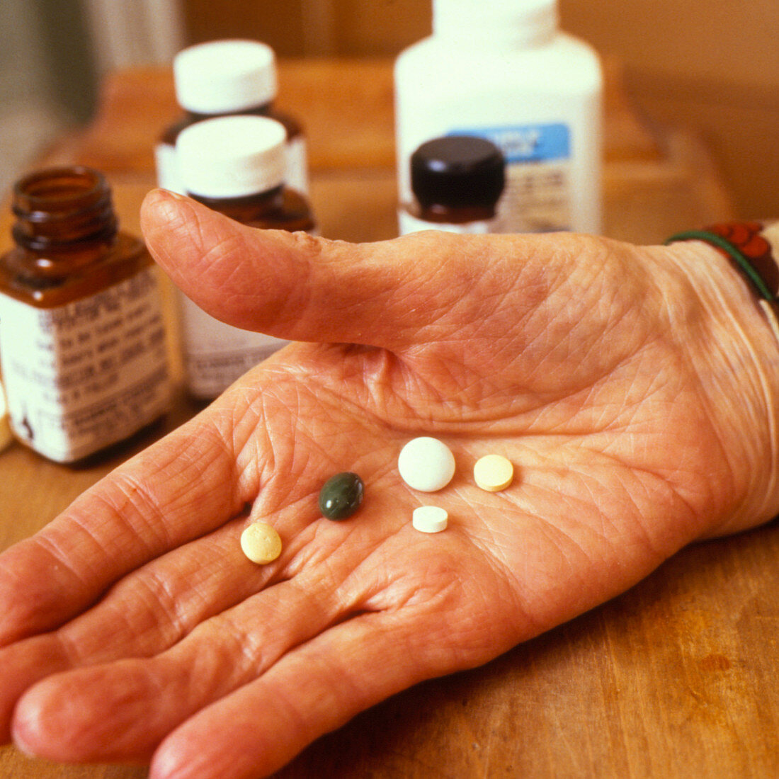 Elderly woman's hand holding drugs