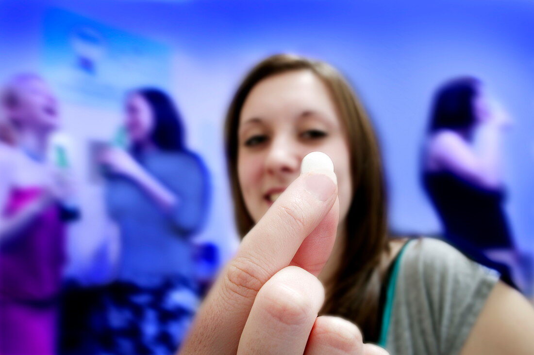 Woman holding hangover pill