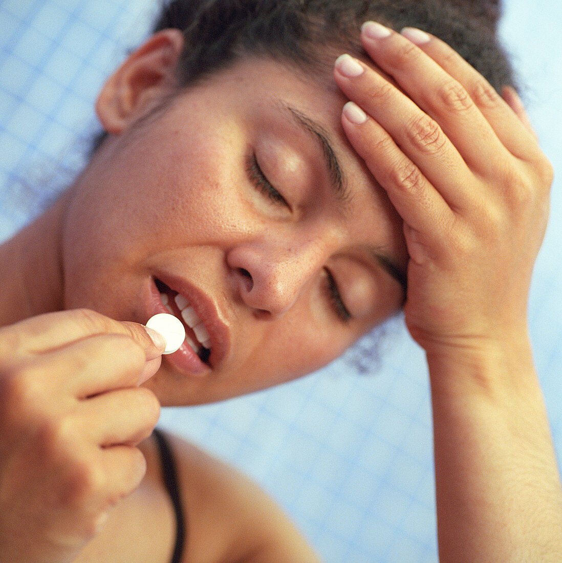 Woman taking painkiller