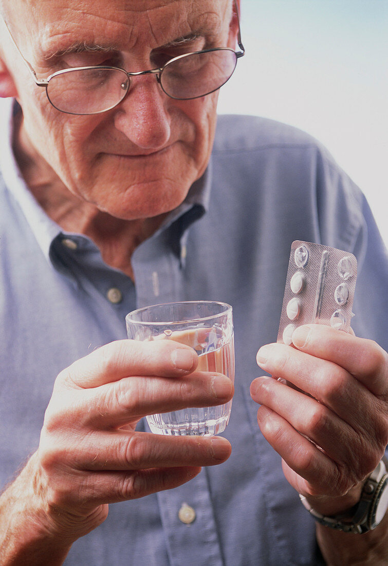 Elderly man taking medication