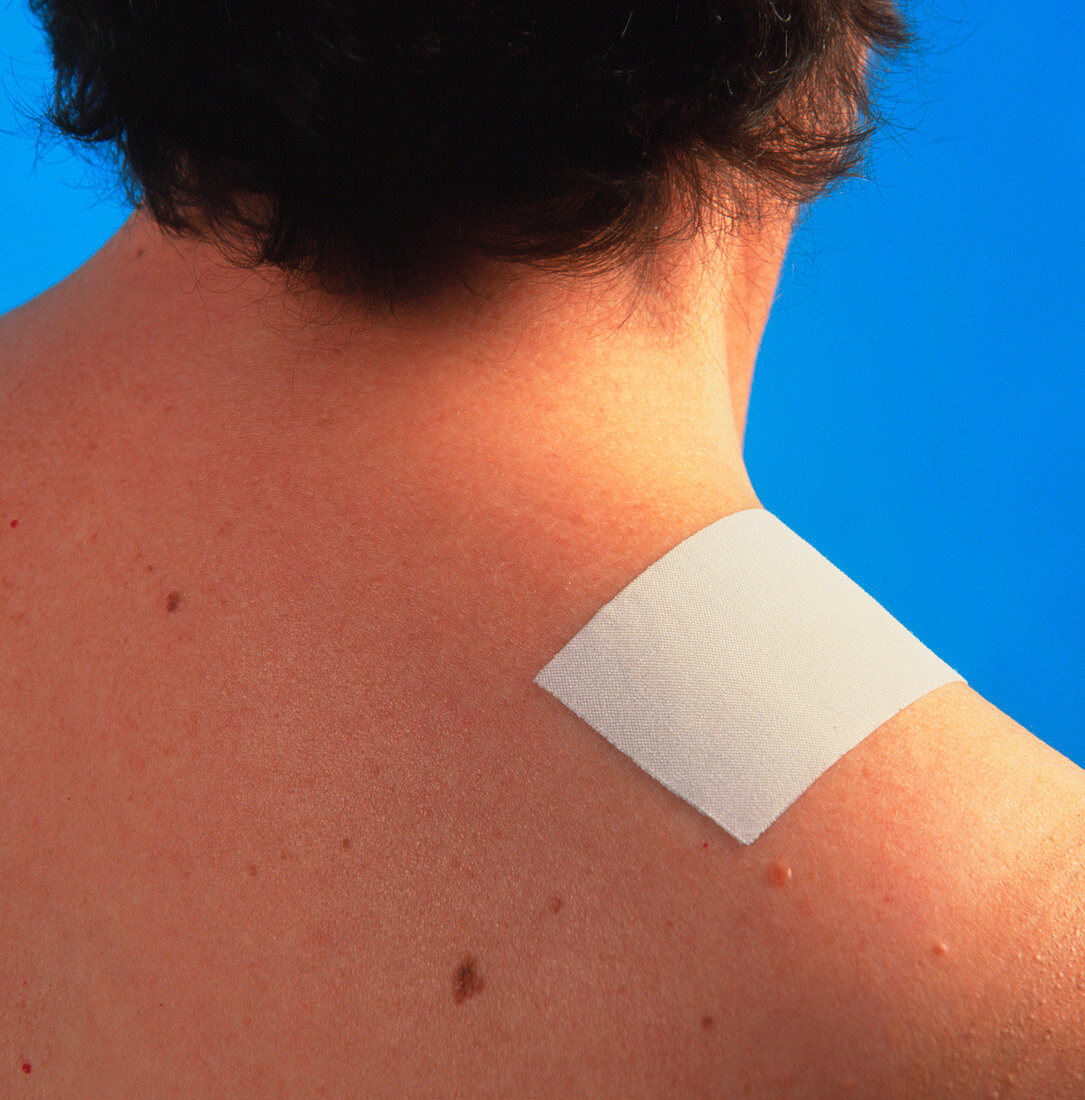 Pain-relief patch on a patient's shoulder