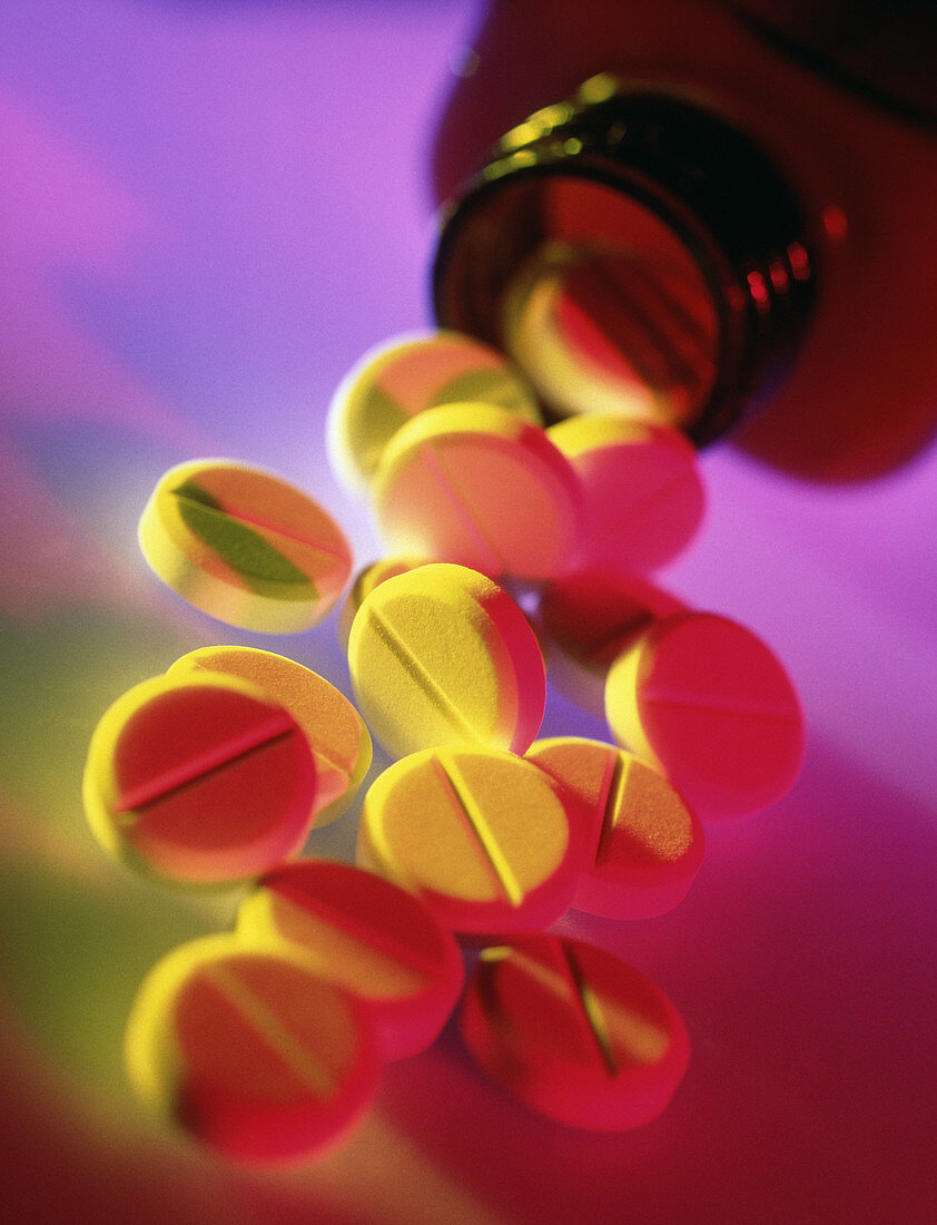 Painkilling (analgesic) pills spilling from bottle