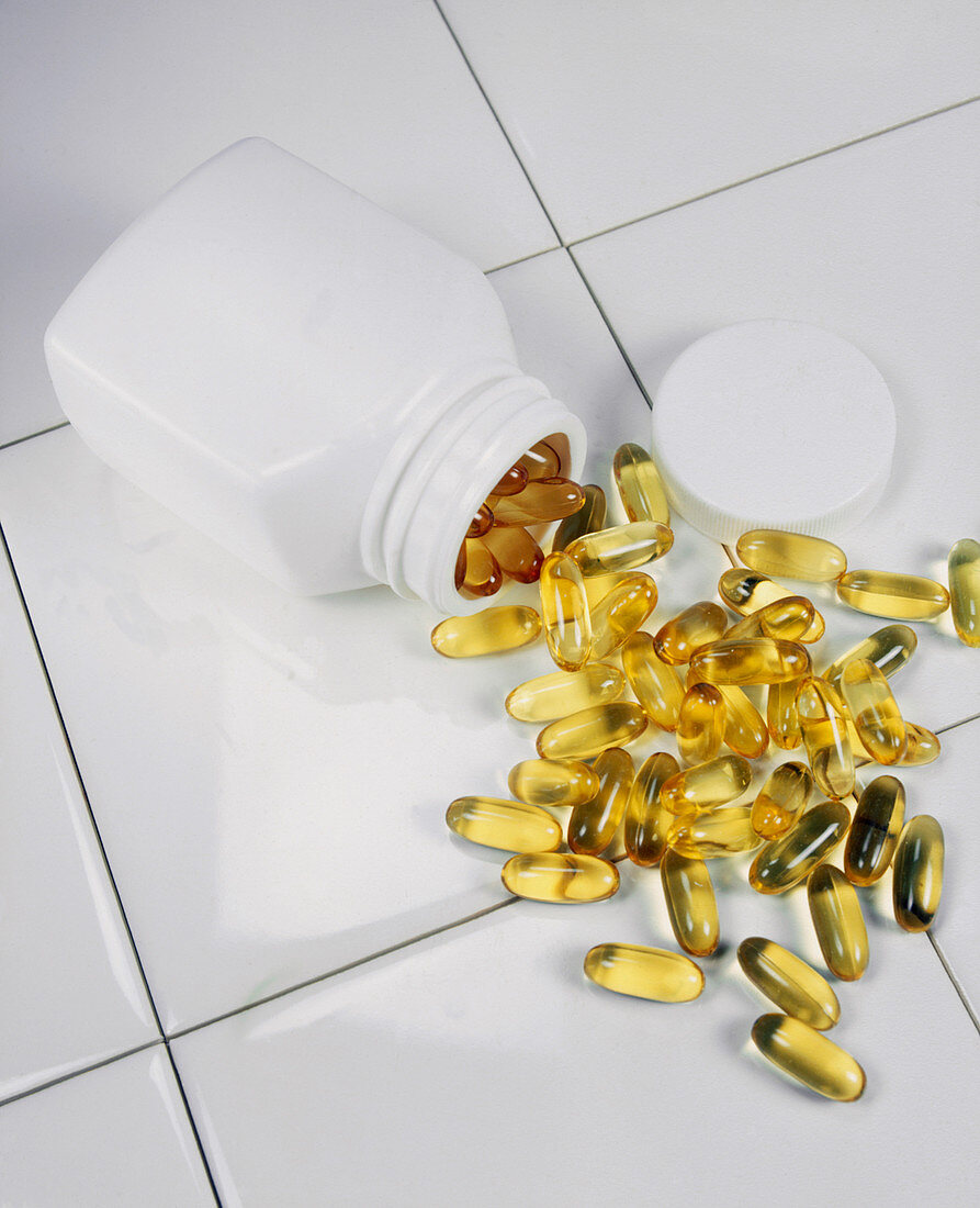 Scattered cod liver oil or vitamin E pills