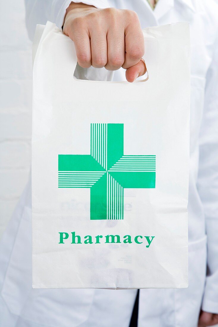 Pharmacist carrying a pharmacy bag