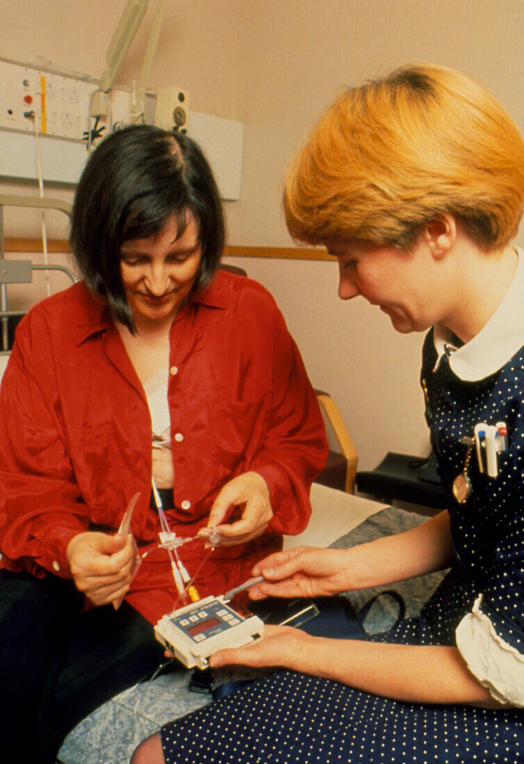 Woman being fitted with a breast cancer drug pump
