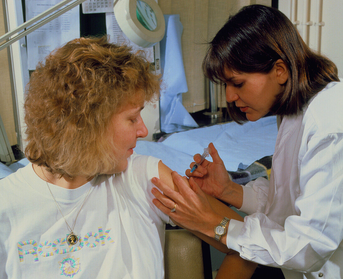 Nurse gives inoculation for flu/hepatitis A
