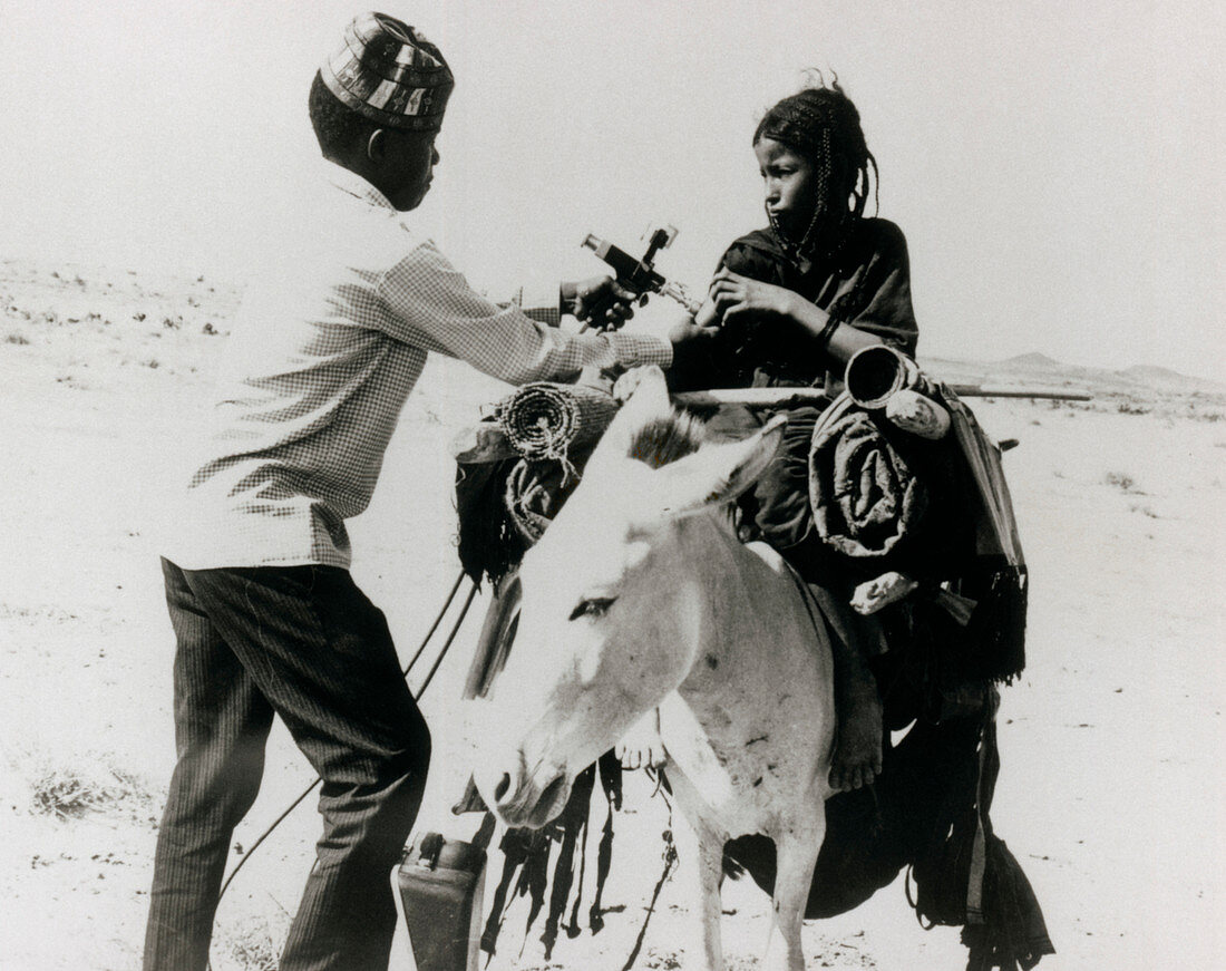 Immunization of girl on a donkey,Africa