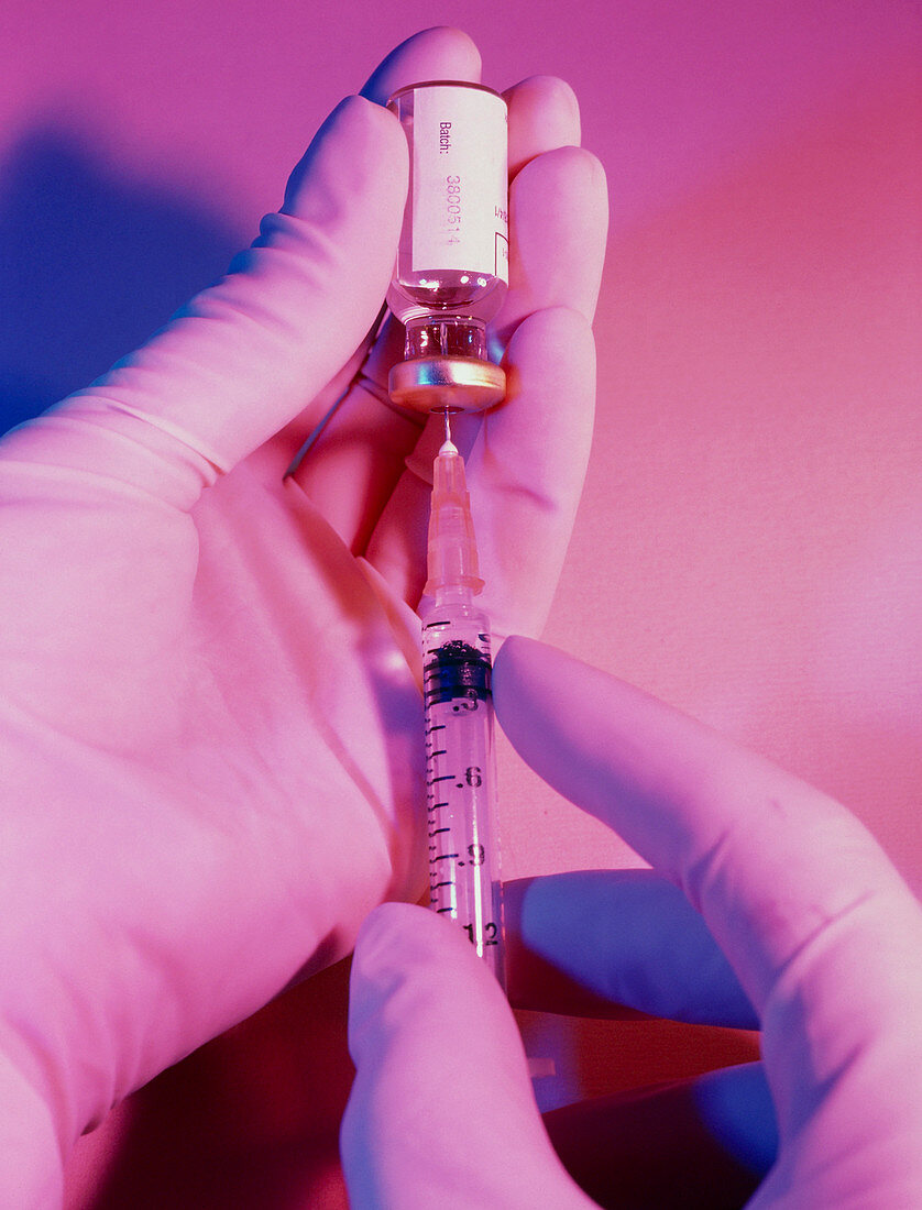 Hypodermic needle and syringe being filled